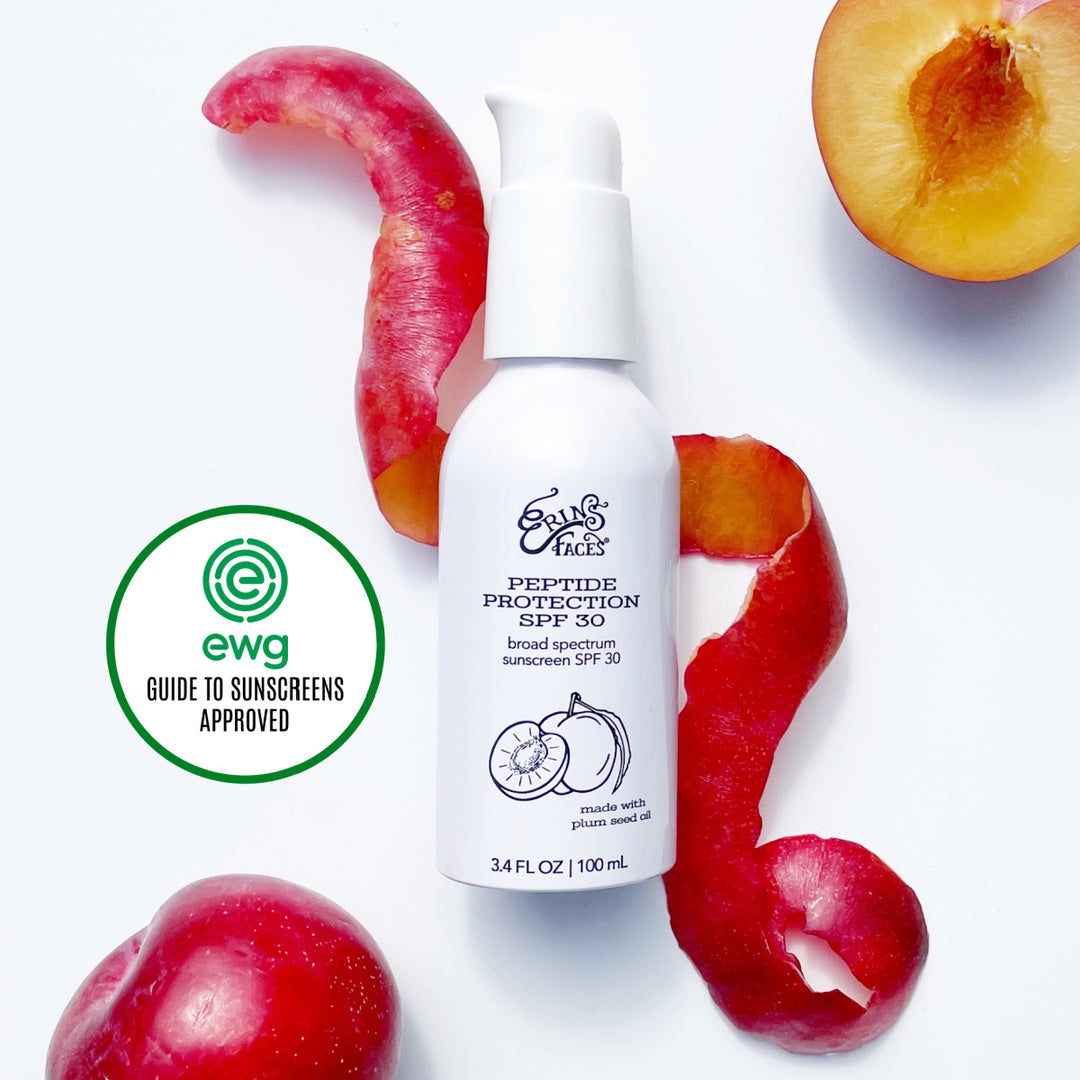 erin's faces peptide protection spf 30 bottle with a plum peel twirled around the bottle on white background - bottle is white too - slice of plum in photo as well + ewg guide to sunscreens approved graphic