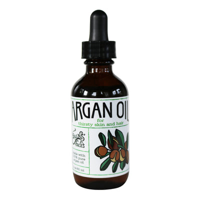 argan oil in a amber glass bottle with a black dropper and white label