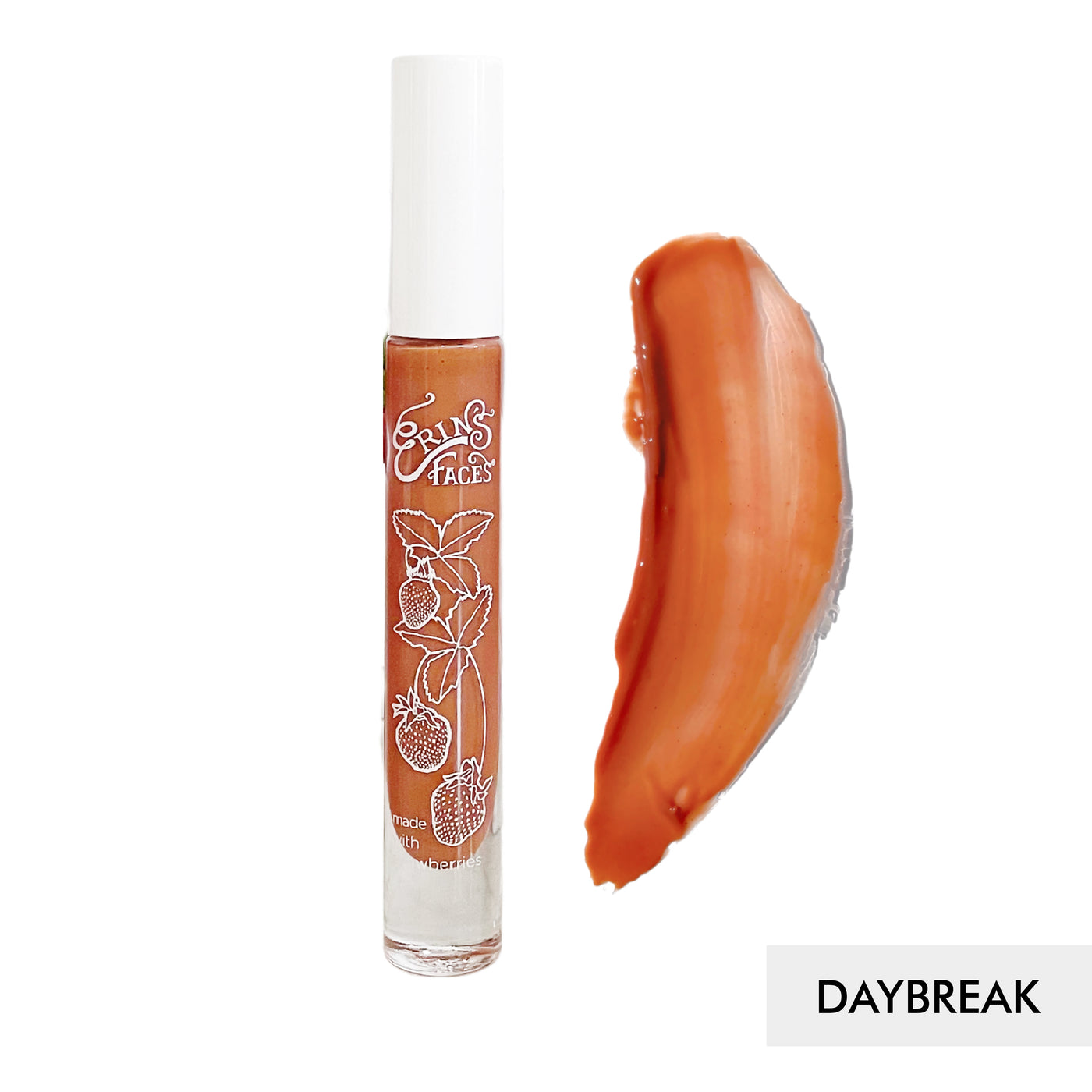 erin's faces fruit smoothie lip gloss bottle and swatch against white background of the shade daybreak