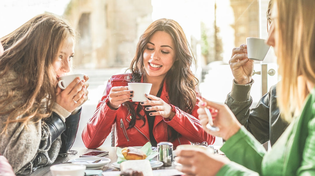 three young women sitting at a lunch table, smiling