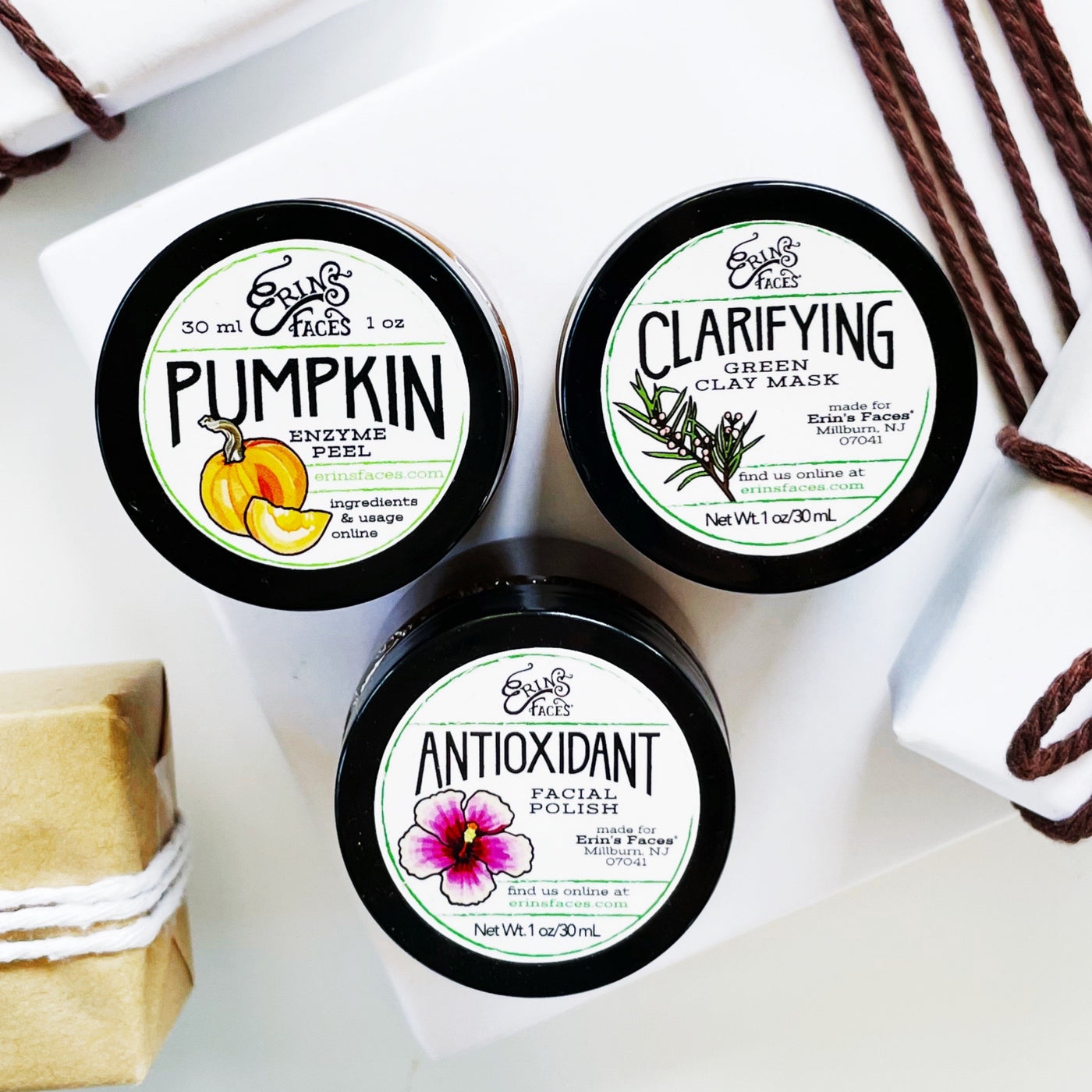 3 mask minis - pumpkin enzyme peel, clarifying green clay mask and antioxidant facial polish surrounded by presents