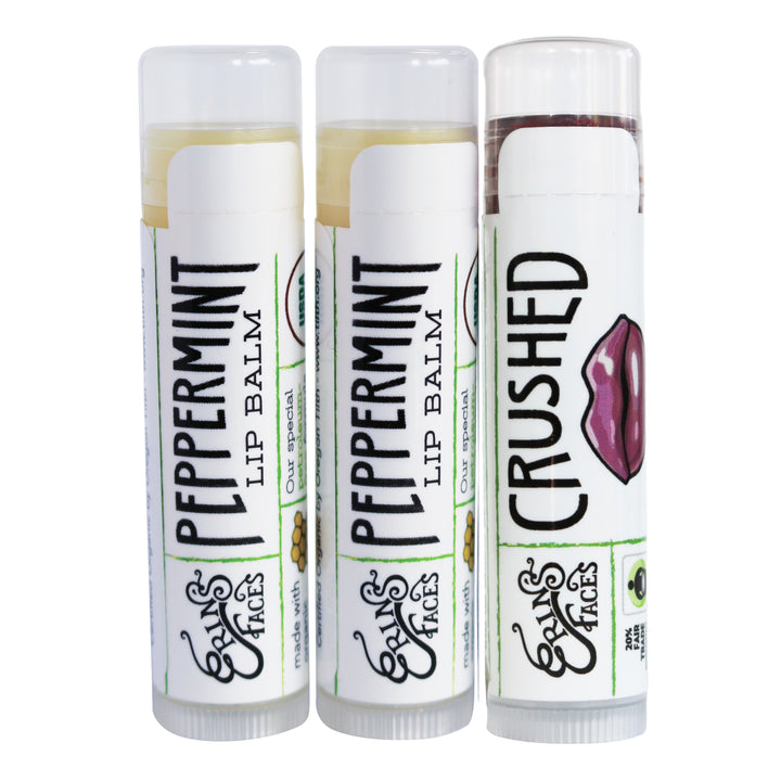 two peppermint lip balms - clear - and one tinted lip balm in crushed with mauve lips on the tube