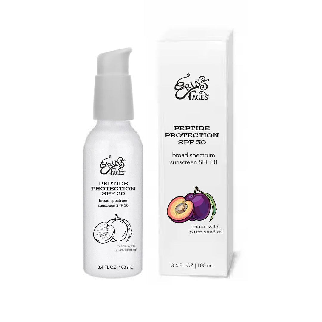 white bottle of sunscreen with white box  - both have plum illustrations on them - box illustration is in color