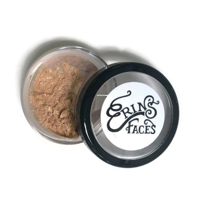 open container of the fairy dust shimmer face powder makeup with lid on the side